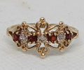 9YG 2.3G 4 GARNET & DIA SET CLW SCROLL RING | SIZE T - PRE OWNED